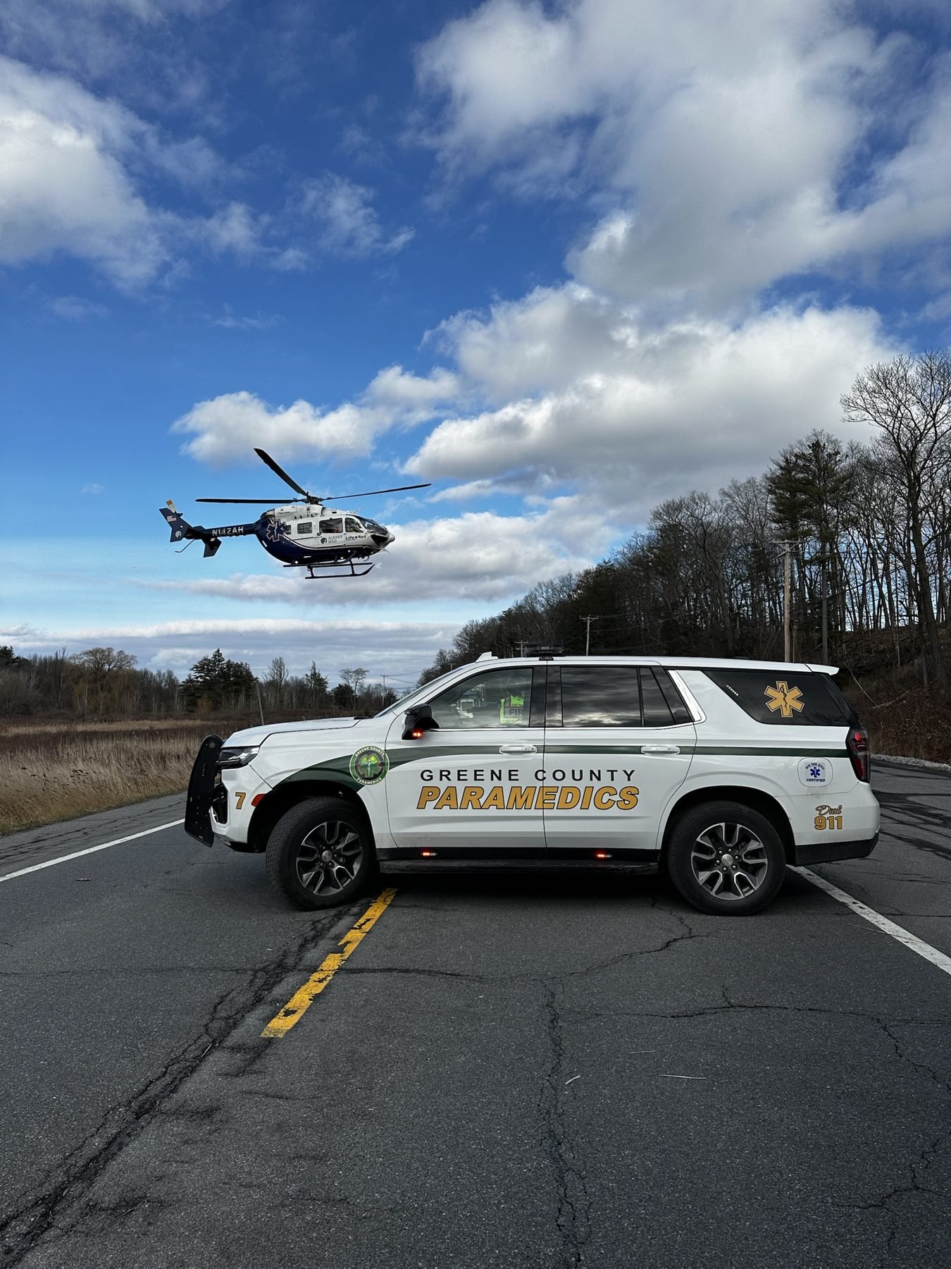 Medic 7 holding a mountain road while a LifeNet helicopter lands